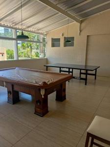 a room with two ping pong tables in it at Apartamento Riviera Velas in Bertioga