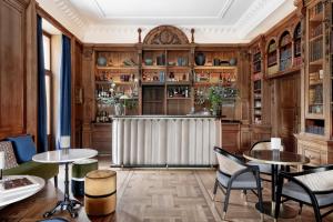 a room with tables and chairs and a radiator at Palacio Arriluce Hotel in Getxo