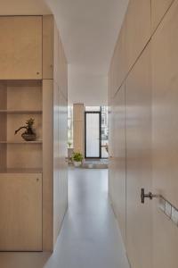 a hallway with a pivot door and a window at LE GARAGE Downtown serviced apartment in The Hague