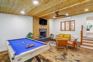 a living room with a pool table and a couch at Luxury Savannah Retreat Heated Pool and Pet Friendly in Savannah