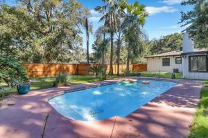 a swimming pool in the yard of a home at Luxury Savannah Retreat Heated Pool and Pet Friendly in Savannah