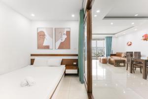 a bedroom with a bed and a dining room at Hanoi Westlake Homestay in D'Le Roi Soleil Building in Hanoi