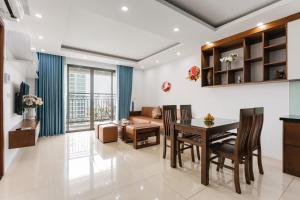 a living room with a table and a couch at Hanoi Westlake Homestay in D'Le Roi Soleil Building in Hanoi