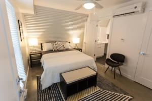 a bedroom with a bed and a desk and a chair at Moon 101 - Full Moon Suite - 2BR 2 5 Bath + Living in New Orleans