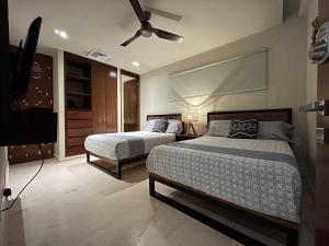 a bedroom with two beds and a ceiling fan at Habitación Privada Riviera Maya, Playa del Carmen! in Playa del Carmen +19 photos