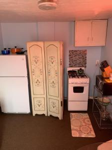 a kitchen with two refrigerators and a stove at Break Side Studio #5 apts in North Camellia Acres