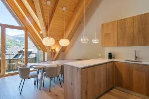 a kitchen and dining room with a table and chairs at Luderna - Duplex Corilha in Gessa +13 photos