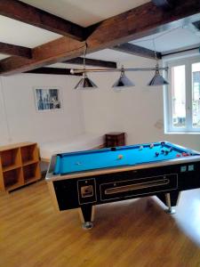 a room with a pool table in a room at La stufa rossa in Sondrio