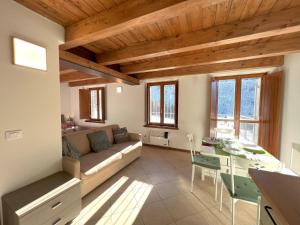 a living room with a couch and a table at Affittimoderni Ponte di Legno Ski - PDL23 in Ponte di Legno