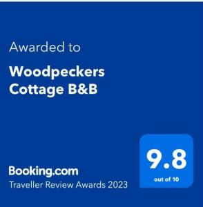 um ecrã de telefone azul com as palavras pintadas para conferência de quebra-madeiras bbb em Woodpeckers Cottage B&B em Pett