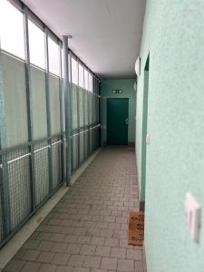 an empty hallway of a building with a green door at Cozy Studio in neighbourhood with Prague in Beroun