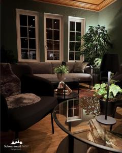 a living room with a couch and a table at Schwarzwaldhotel Gengenbach in Gengenbach