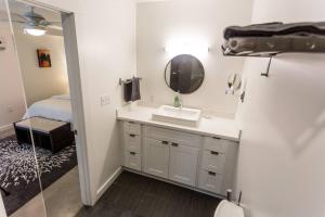 baño con lavabo, espejo y cama en Moon 401 - Half Moon Suite - 2BR - 2 Bath en Nueva Orleans