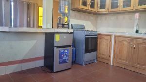 a kitchen with a stove and a dishwasher at Hostal Sweet Dreams in Panajachel