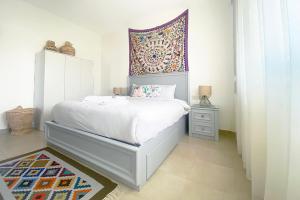 a bedroom with a bed with a tapestry above it at Soma Bay Sea View Penthouse in Hurghada