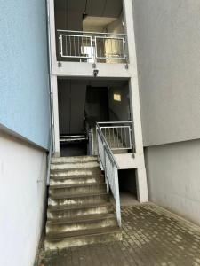 a stairway leading to a building with a balcony at Cozy Studio in neighbourhood with Prague in Beroun