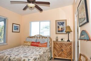 a bedroom with a bed and a ceiling fan at Parrot Eyes Lower in Tavernier