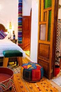 a bedroom with a bed and an open door at Riaad Hamad in Fez