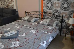 ein Bett mit blauer Bettdecke und Blumen drauf in der Unterkunft Uneed Rooms - Cloud 9 in Kiew