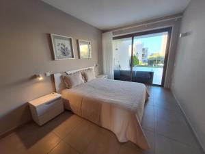 a bedroom with a large bed and a large window at Lightoasis Oasis Mar B0A in Portimão