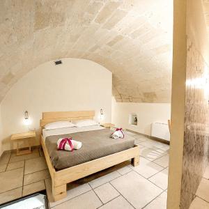 a bedroom with a bed with two pillows on it at Mikasa in Matera