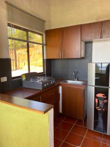 a kitchen with a sink and a stove top oven at Casa Del Viento, Alojamiento in Villanueva