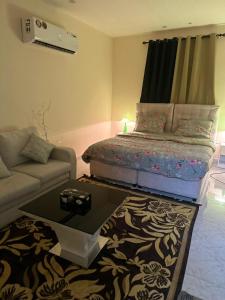 a living room with a bed and a couch at luule in Al Ain