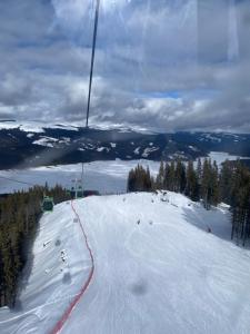 a ski lift going down a snow covered slope at Enduro Transalpina in Obarsia-Lotrului