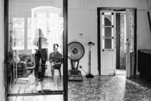 a man standing in a living room looking in a mirror at Ceglarnia in Książ Wielkopolski