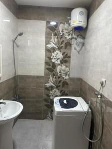 a bathroom with a toilet and a sink at luule in Al Ain