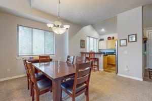 a kitchen and dining room with a wooden table and chairs at Eagle Crest Family Retreat in Redmond