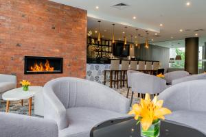 a lobby with white chairs and a fireplace at Jose Antonio Deluxe in Lima