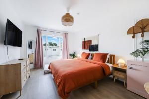 a bedroom with a large bed and a television at Tropics Hotel Miami Beach in Miami Beach