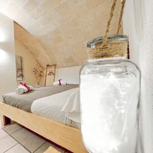 a bottle of milk sitting next to a bed at Mikasa in Matera