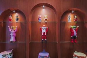 a bunch of toy figurines are on shelves at Ma Muan Budget & Boutique Chiang Mai in Chiang Mai