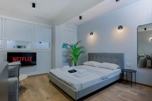a bedroom with a bed and a living room at Luxury Downtown Apartment Α2 in Thessaloniki