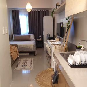 a room with a bed and a kitchen with a sink at Cavite Budget Airbnb with Resort-like Amenities in Dasmariñas