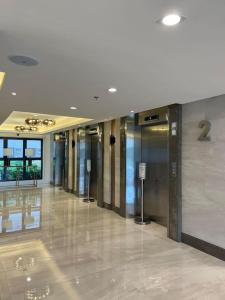 a building with a hallway with elevators in it at Cavite Budget Airbnb with Resort-like Amenities in Dasmariñas