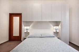 a bedroom with a large bed with white cabinets at Casa Cicolani in Scardovari