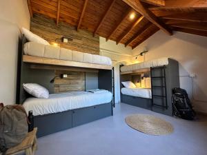a room with two bunk beds and a chair at Warthon Hostel in San Martín de los Andes