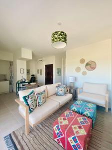 a living room with a white couch and a table at Soma Bay Sea View Penthouse in Hurghada