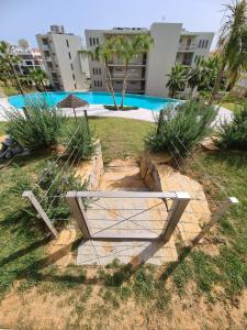 a bench sitting in the grass in front of a building at Lightoasis Oasis Mar 3 in Portimão