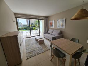 a kitchen and living room with a table and a couch at Lightoasis Oasis Mar 3 in Portimão