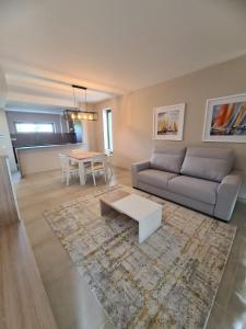 a living room with a couch and a table at Lightoasis Oasis Mar 3 in Portimão