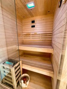 a sauna with wooden walls and wooden floors at Sunshine Apartments Golte - Sauna in Mozirje