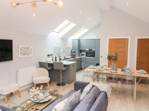 a living room and kitchen with a couch and a table at 2 Russell Court in Salcombe