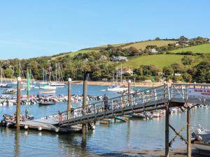 a pier with a bunch of boats in the water at 2 Russell Court in Salcombe