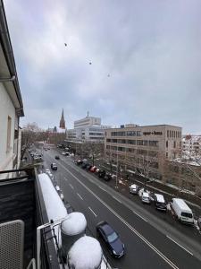 a view of a city street with cars in the snow at Stadtzentrum Appartement in Hannover