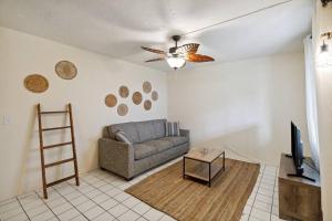 a living room with a couch and a television at Beach Bungalows By The Sea 3 in Cocoa Beach
