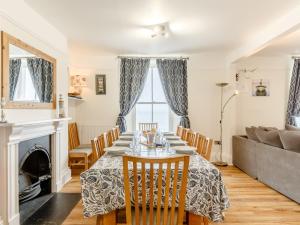 a dining room with a table and chairs and a couch at 6 bed in Cawsand 59006 in Kingsand